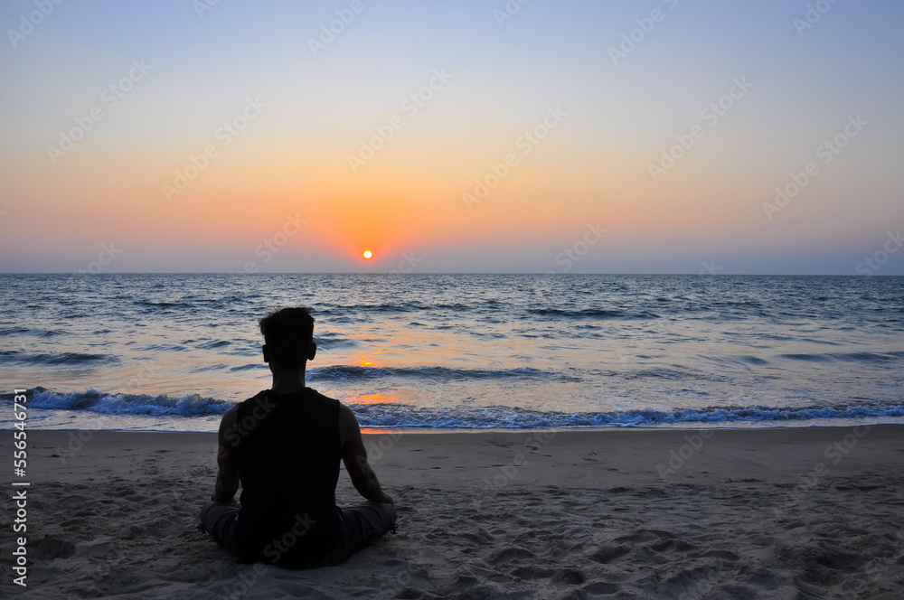 Evening meditation overlooking the sea in Arambol, Goa, India