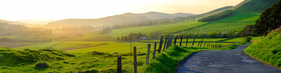 Acrylglasbilder Pistache Panorama Of A Rural Road In Scotland At Sunset  © Mr Doomits