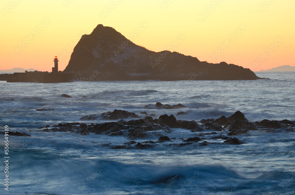 Lighthouse and islet at sunset in Utoro. Shiretoko Peninsula. Hokkaido. Japan.
