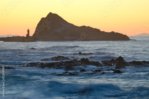 Lighthouse and islet at sunset in Utoro. Shiretoko Peninsula. Hokkaido. Japan.