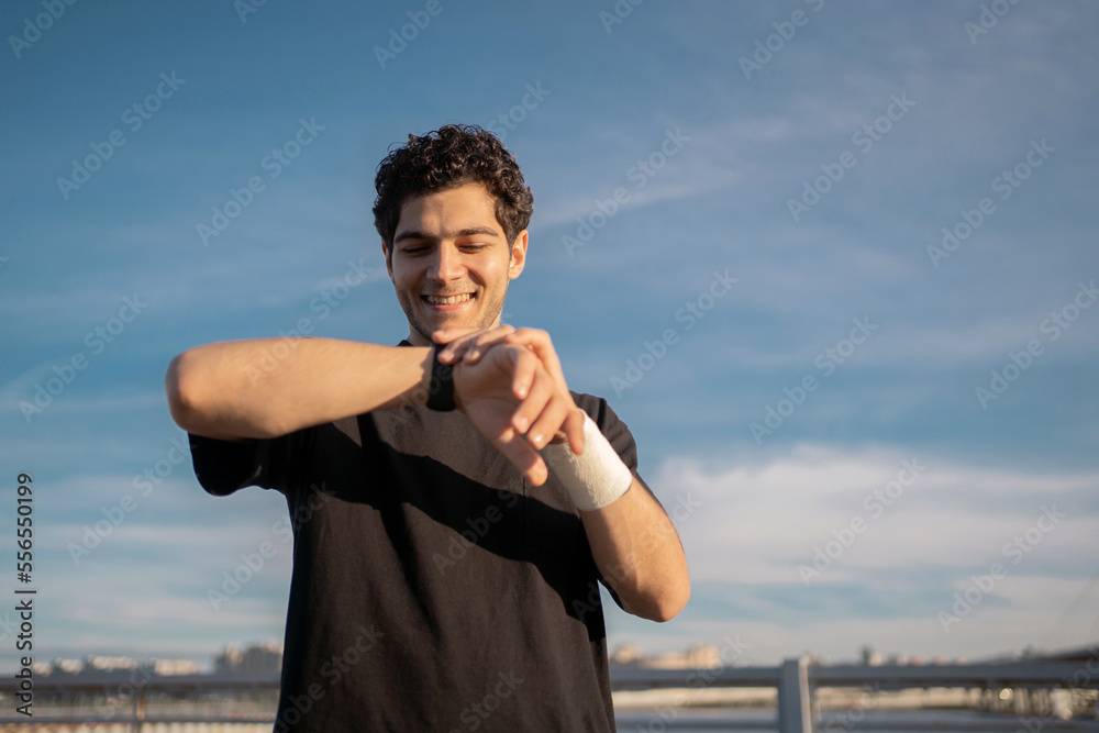 Fototapeta premium Fitness Watch on Hand Trainer exercise for fitness. A man is a strong active sport every day.