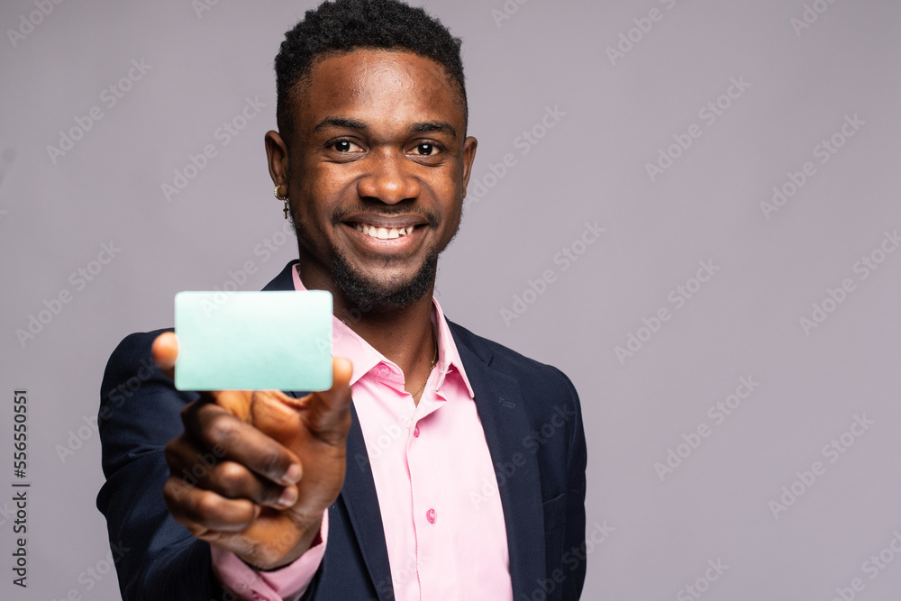 smiling african businessman showing a plain card smiling african businessman showing a plain card