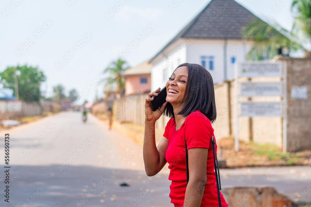 pretty african lady making a phone call laughing
