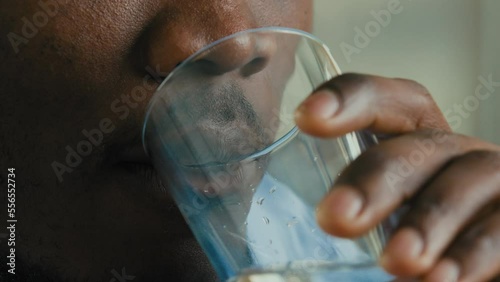 Healthy male businessman unknown african american man adult young guy employee drinking cold mineral fresh water keep aqua balance quench thirst good daily habit body hydration health care weight loss