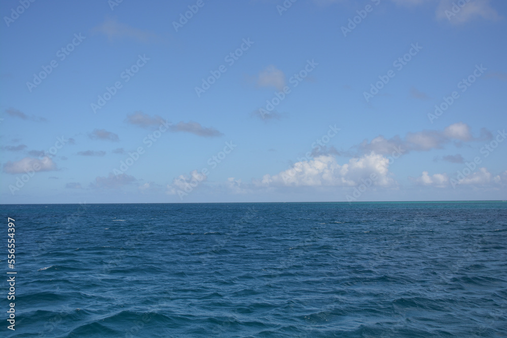Azure Caribbean sea meets blue sky. Space for copy.  