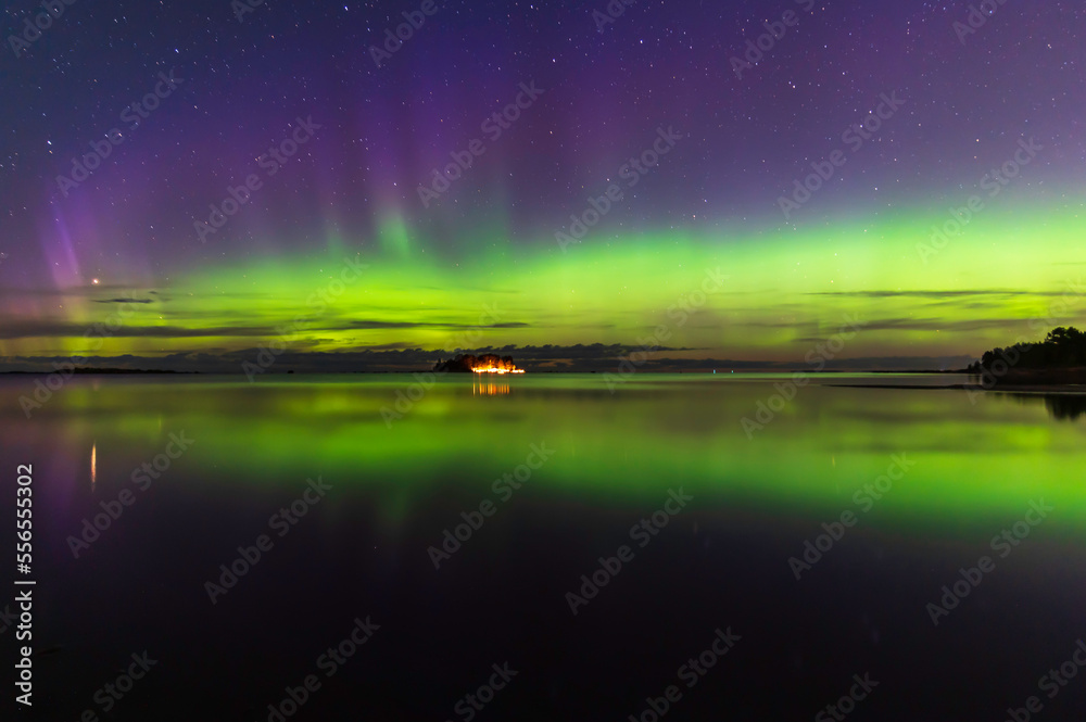 Northern lights, reflections in the water. Storsand Jakobstad/Pietarsaari. Finland