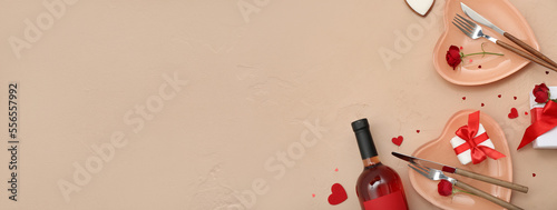 Stylish table setting for Valentine's Day with wine on beige background with space for text