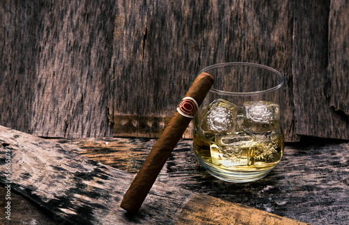 Glass of whiskey on the rocks and cigar.