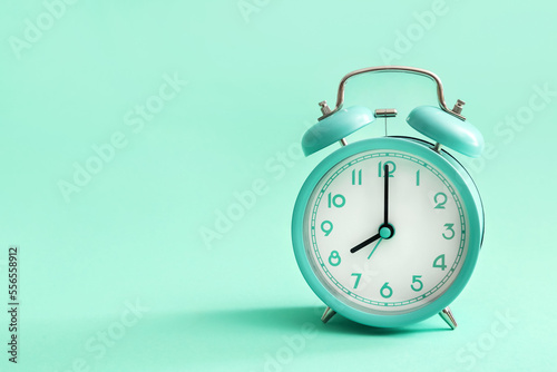 Vintage alarm clock on blue background