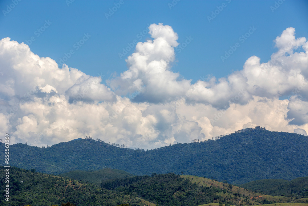 Clouds in dramatic formation over the chain of hills, with blue sky on countryside of Brazil