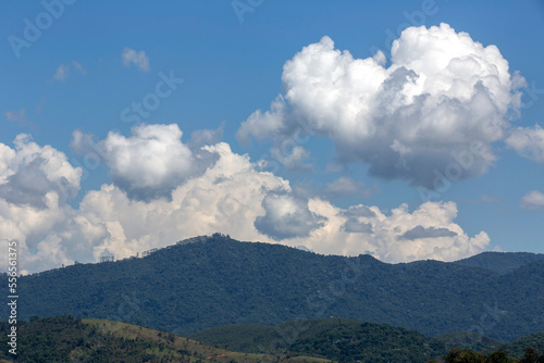 Clouds in dramatic formation over the chain of hills, with blue sky on countryside of Brazil. Space for text