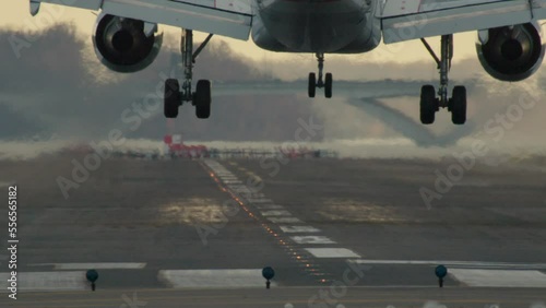 Slow Motion Close-Up Of Plane Landing On Runway photo