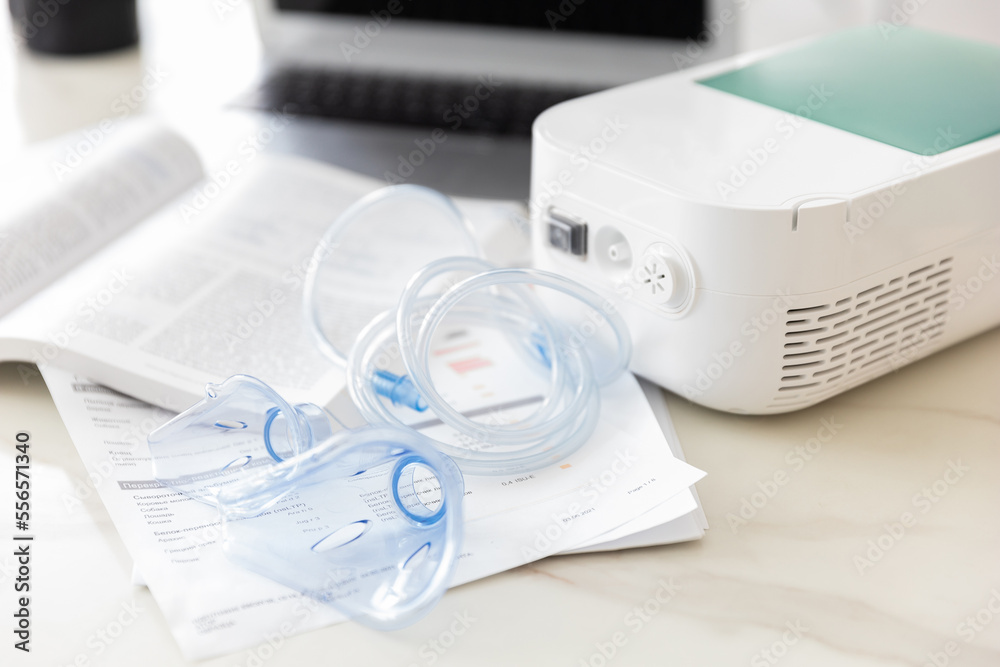 nebulizer on the table in a bright office, treatment of asthma and bronchitis.close up nebulizer on the table in a bright office, treatment of asthma and bronchitis.close up
