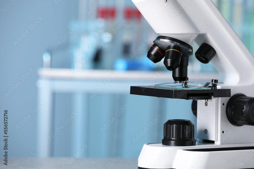 Modern medical microscope in laboratory, closeup. Space for text Modern medical microscope in laboratory, closeup. Space for text