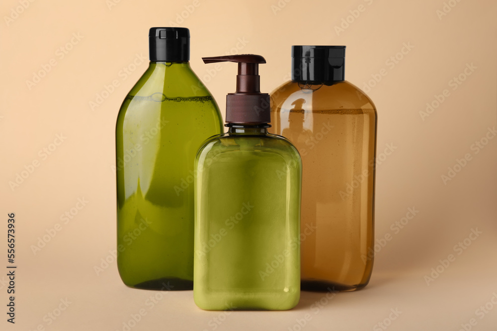 Different bottles of shampoo on beige background Different bottles of shampoo on beige background