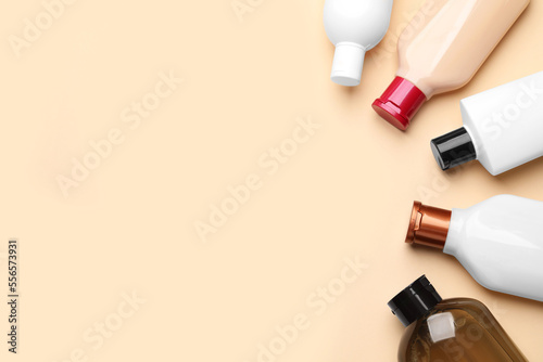 Bottles of shampoo on beige background, flat lay. Space for text © New Africa