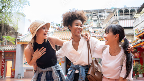 Young happy multi ethnicity tourists sightseeing in city. Diversity people African, Asian, Caucasian friends travel holiday together in China town.