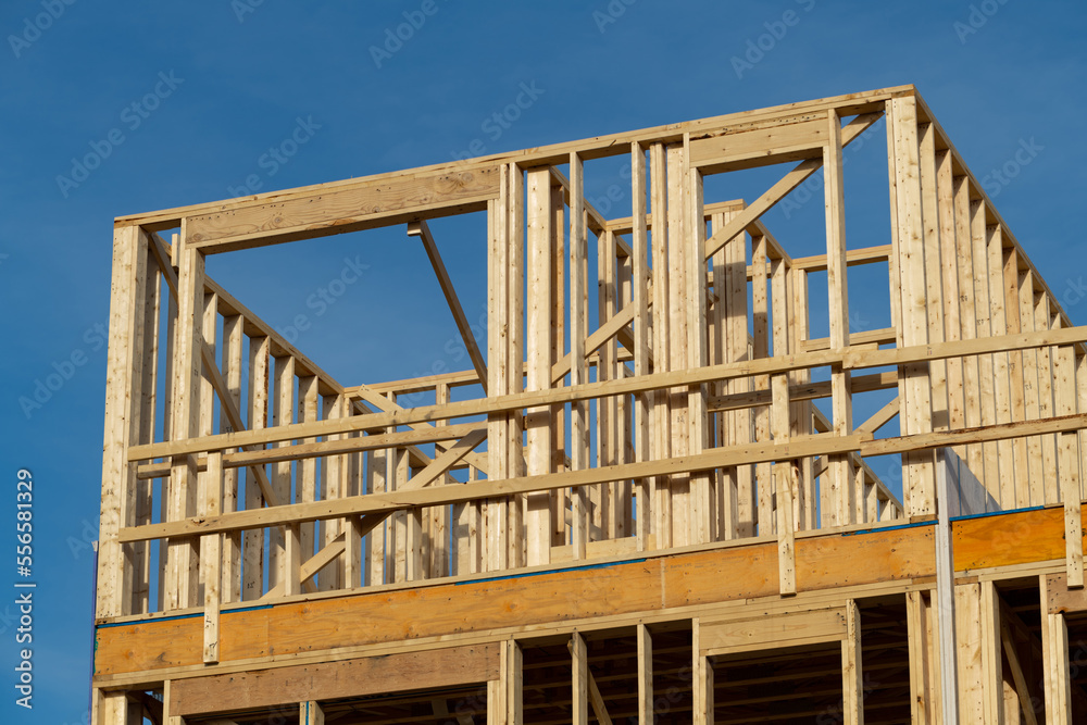 Obraz premium wooden frame of the house aganist the blue sky