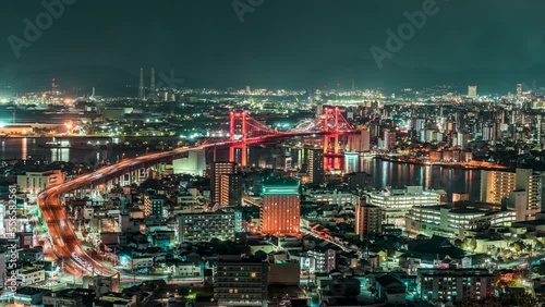 Night Time lapse of Kitakyushu City with Wakato Bridge from Takatoyama Observatory. Fukuoka Japan. Landmark in Business downtown in Kitakyushu Fukuoka Japan. Public transport Business District photo