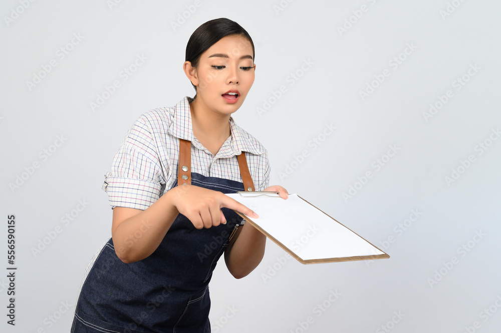 Portrait of young asian woman in waitress uniform pose with clipboard Portrait of young asian woman in waitress uniform pose with clipboard