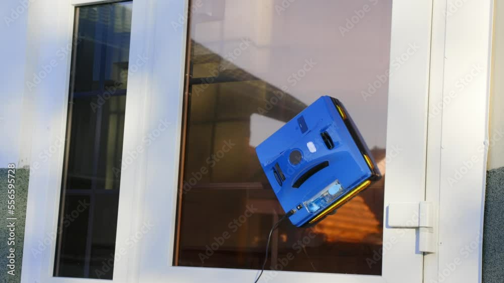 Automatic window washer moves on the glass thoroughly washes dirt