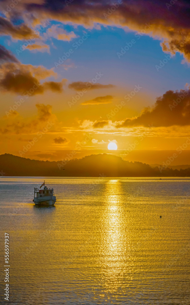 Aerial sunrise waterscape with boats, clouds and reflections