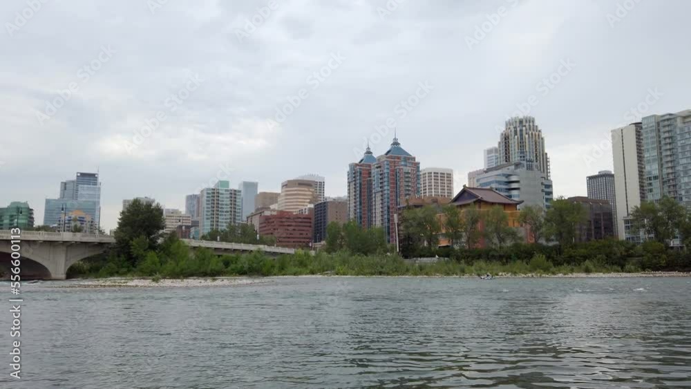 City river by bridge with boat floating on cloudy day Calgary Alberta Canada City river by bridge with boat floating on cloudy day Calgary Alberta Canada