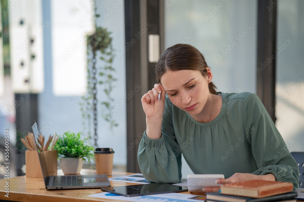 Portrait of a female office worker feeling stressed while working in the office room. Portrait of a female office worker feeling stressed while working in the office room.