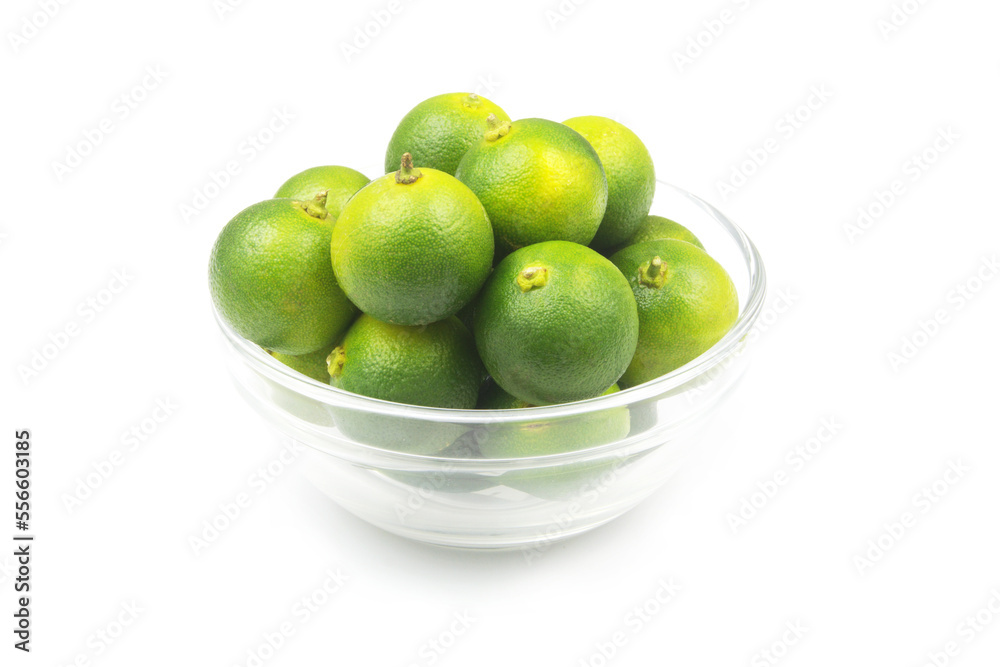 Lime fruits in glass bowl isolated on white background. Lime fruits in glass bowl isolated on white background.