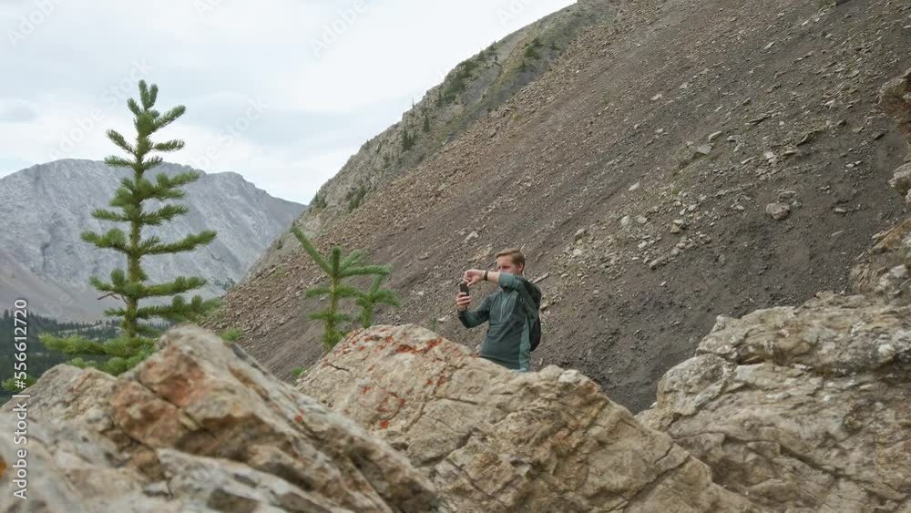 Hiker taking photos in the mountains Rockies Kananaskis Alberta Canada Hiker taking photos in the mountains Rockies Kananaskis Alberta Canada