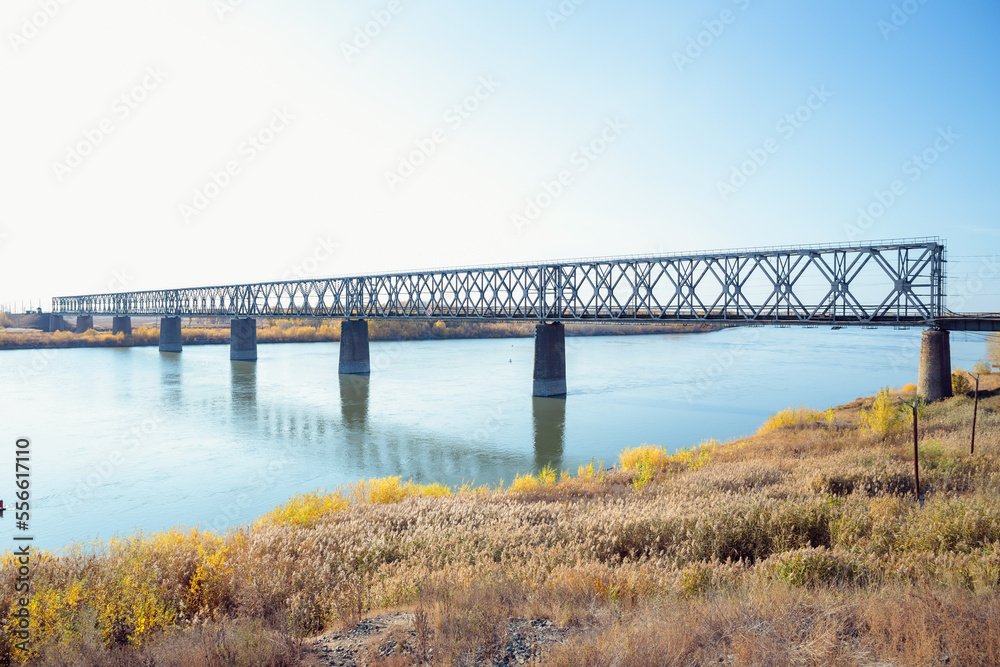 Railway bridge over river on sunny autumn day. Railway bridge over river on sunny autumn day.