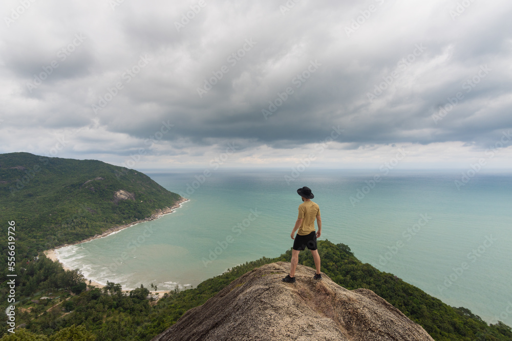 man in a top of view point on bottle beach, blue sky with clouds and beautiful tropical beach,koh phangan, Ko Pha-ngan, Surat Thani,thailand