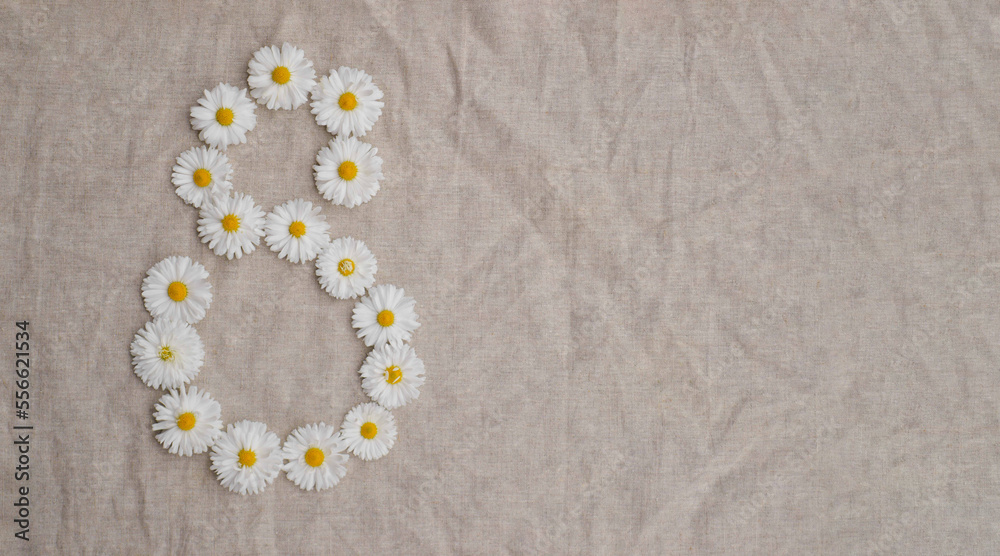 Figure eight of the daisy buds on a linen background. Isolate. Copy space. International Women Day background Figure eight of the daisy buds on a linen background. Isolate. Copy space. International Women Day background