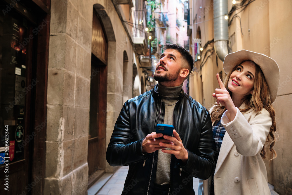 Couple visiting a city and using a mobile phone
