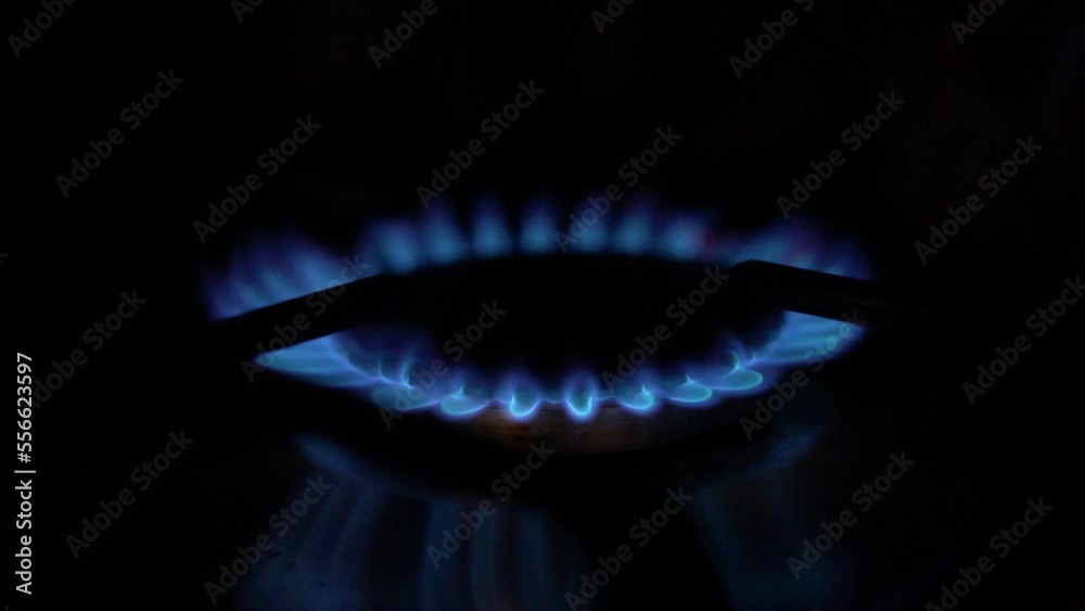 Burning Gas Burner in the Dark, Closeup. Lit Burner Gas Blue Flame Gas Stove. Burning Gas Burner in the Dark, Closeup. Lit Burner Gas Blue Flame Gas Stove.