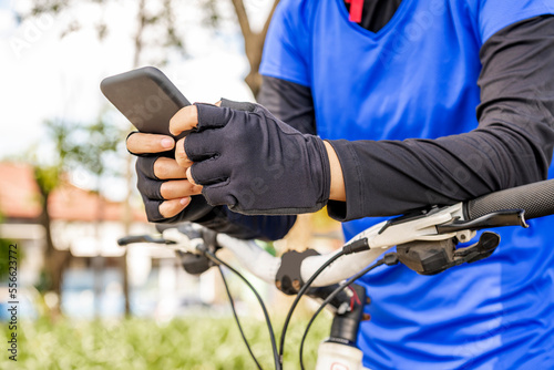 Woman using smartphone while sitting on her bicycle