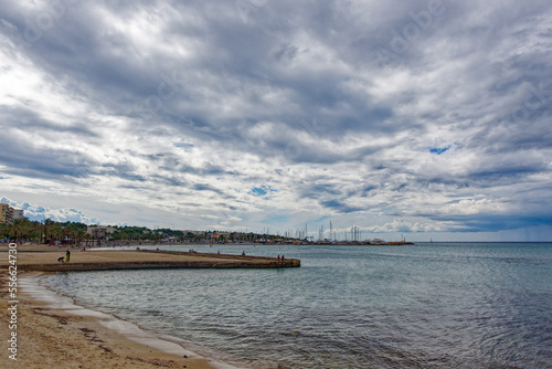 Wallpaper Mural Tourists relaxing at beach S’Arenal of Mallorca Island and swimming in the ocean with mountain panorama in the background on a blue cloudy autumn day. Photo taken October 12th, 2022, Mallorca, Spain. Torontodigital.ca