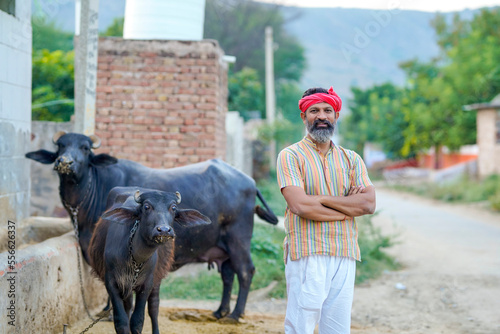Rural scene : Indian farmer standing his dairy farm