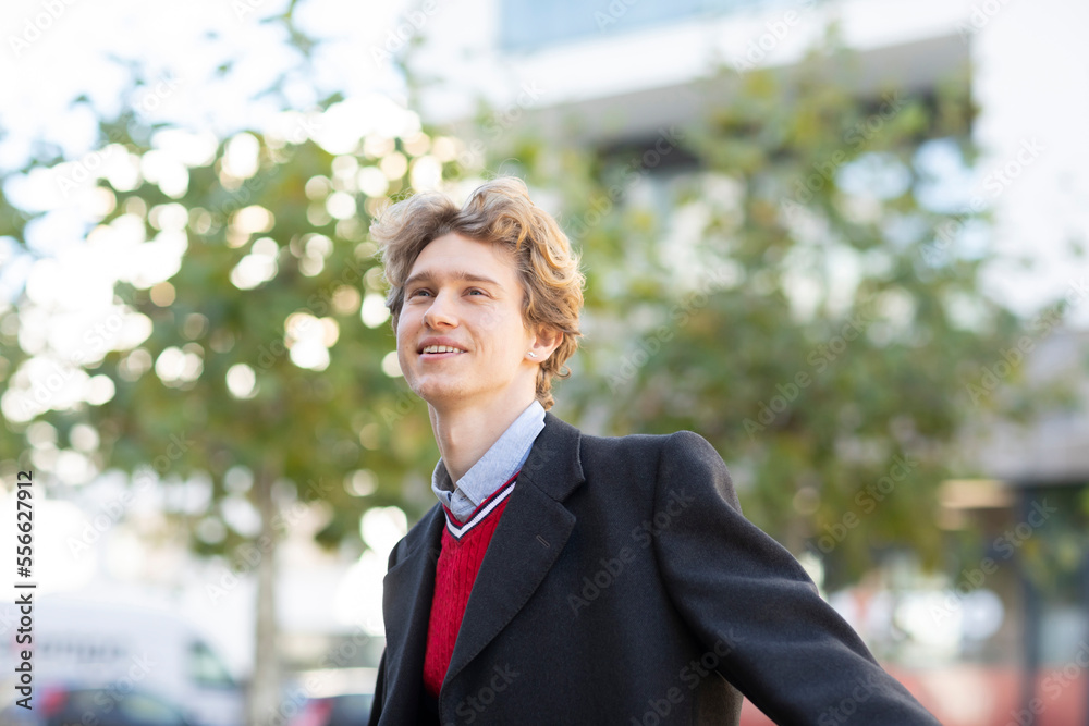 Smiling young man with red pullover and jacket Smiling young man with red pullover and jacket