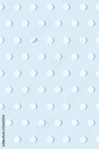 Health and pharmacy remedies for prevent and teraphy disease and illness background - white pills seamless pattern on pastel blue color in hard light with shadow, top view, vertical.