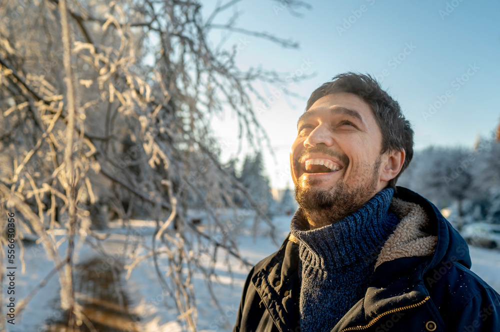 Happy man enjoying winter at park Happy man enjoying winter at park