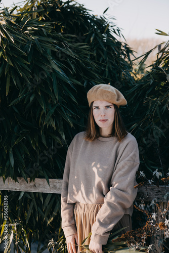 Woman with barret standing in garden