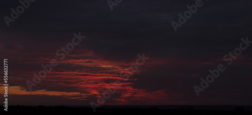 Purple-magenta clouds. Tragic gloomy sky. Landscape with bloody sunset. Fantastic skies on the planet earth. Twilight, nightfall. Blackout.