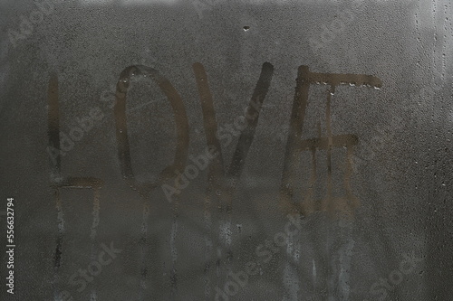 love written on glass. Water drops on window