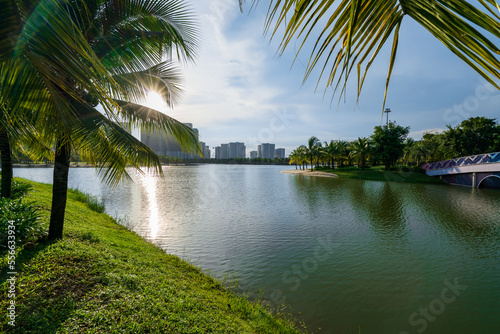 Public green park with modern blocks of flats and blue sky with white clouds in Vietnam