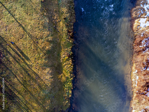 Obraz na płótnie Aerial view. Flowing river, nature, winter, snow, meadow. w salonie