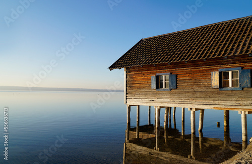 an old wooden boat house in Herrsching on Lake Ammersee in Bavaria on a clear and sunny January evening  Germany  