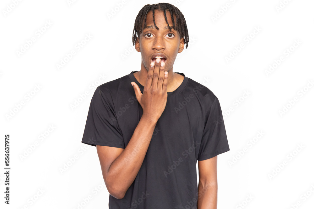 Amazed young man covering his mouth with hand from shock. Male African American model with brown eyes and afro braids in casual clothes opening his mouth from surprise. Astonishment, amazement concept Amazed young man covering his mouth with hand from shock. Male African American model with brown eyes and afro braids in casual clothes opening his mouth from surprise. Astonishment, amazement concept