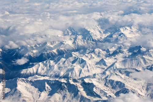 Mountain snow landscape nature from the height of an airplane in the winter season.