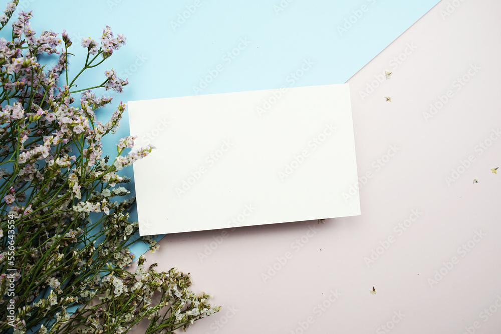 Empty invitation card mockup with flower bouquet on pink and blue background